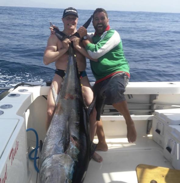 Fishing Charters in Marbella — Big blue marlin landed on our Marbella fishing charter — two anglers, sport-fishing boat