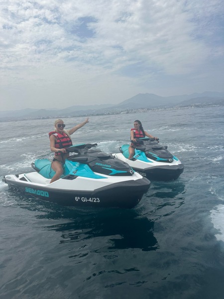 Jet Ski Rental in Marbella — Sea-Doo jet ski rental Marbella — two riders cruising past the Marbella mountains